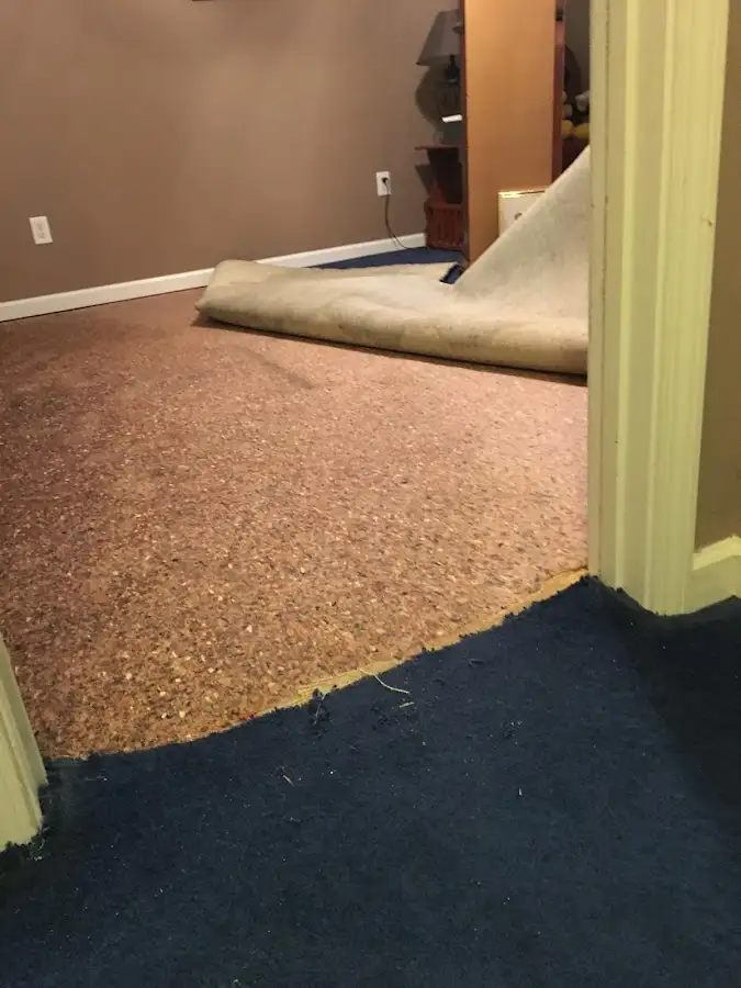 Carpet pad removal revealing water damage during Drying & Dehumidification in Inwood